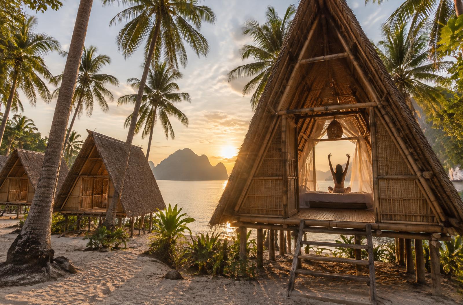 Bamboo beach hut on a secluded shore at sunrise